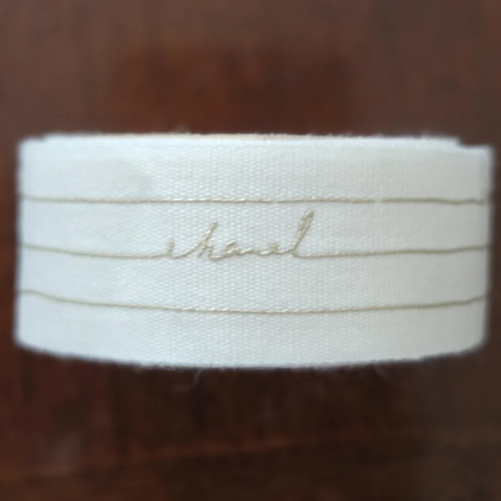 CHANEL White Ribbon With Gold Writing